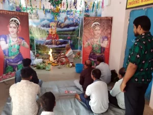 Students and faculty of Janata College, Satmile, Dhenkanal, gathered for Saraswati Puja celebration, offering prayers to Goddess Saraswati with colorful decorations and traditional rituals.