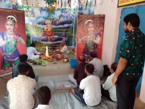 A vibrant Saraswati Puja celebration at Janata College, Satmile, Dhenkanal, with students dressed in traditional attire, participating in prayers and cultural activities.